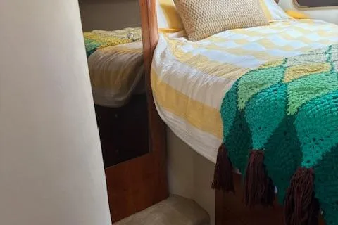  Yacht Photos Pics 2004 Cruisers Yachts 370 Express cabin with cozy bed and colorful blanket.