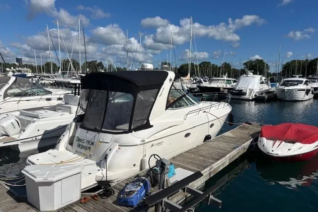  Yacht Photos Pics 2004 Cruisers Yachts 370 Express docked at marina under blue sky.