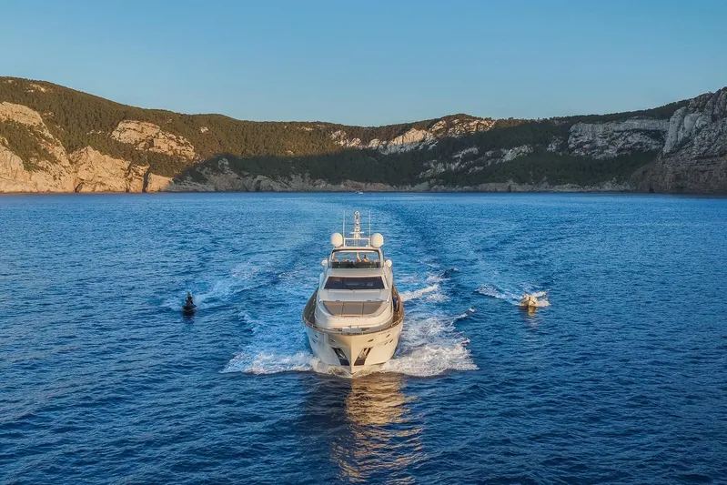 Alacant Yacht Photos Pics Astondoa 102 GLX yacht cruising in scenic coastal waters, 2005 model.