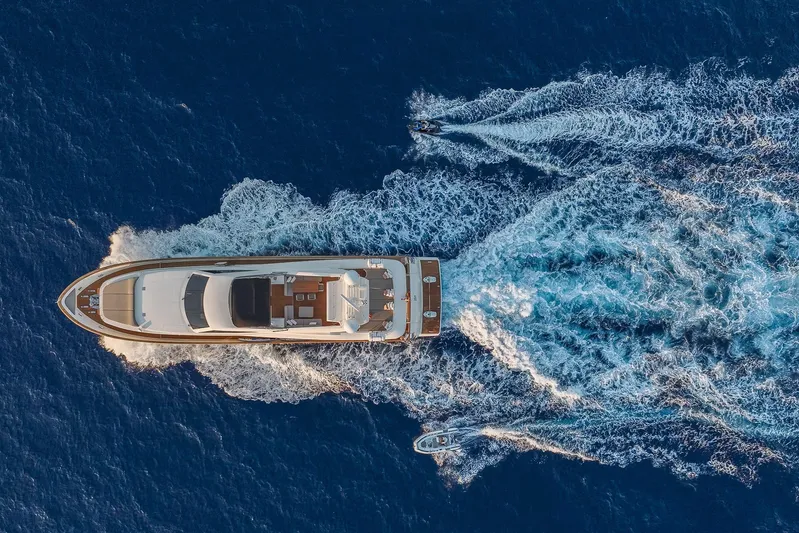 Alacant Yacht Photos Pics Aerial view of 2005 Astondoa 102 GLX yacht cruising with jet ski and boat.