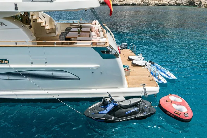 Alacant Yacht Photos Pics Luxurious 2005 Astondoa 102 GLX yacht with jet ski and water toys in clear blue water.