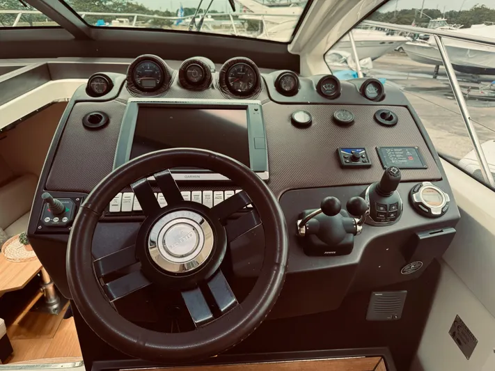  Yacht Photos Pics Control panel of a 2009 Azimut Atlantis 50 yacht with steering wheel and navigation instruments.