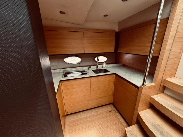  Yacht Photos Pics 2009 Azimut Atlantis 50 yacht kitchen with wooden cabinets and modern appliances.