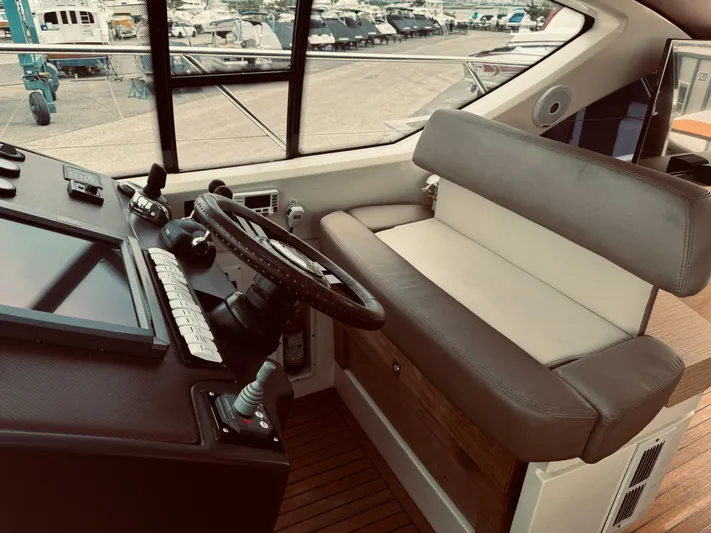  Yacht Photos Pics 2009 Azimut Atlantis 50 yacht helm station with leather seating and modern controls.