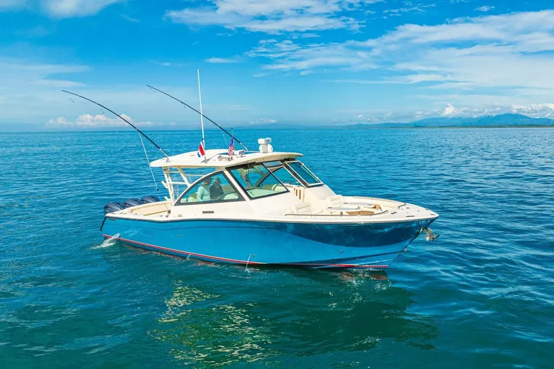 Dos Amigos Yacht Photos Pics 2020 Grady-White Freedom 375 boat on calm blue ocean under clear sky.