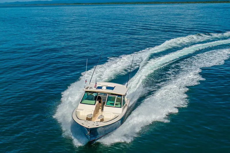 Dos Amigos Yacht Photos Pics 2020 Grady-White Freedom 375 cruising on open blue water, leaving a wake behind.