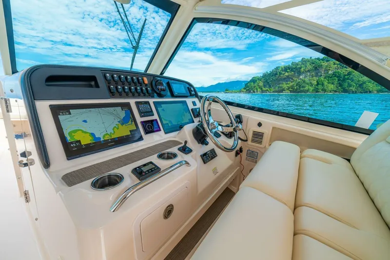 Dos Amigos Yacht Photos Pics 2020 Grady-White Freedom 375 boat interior with navigation system and scenic ocean view.