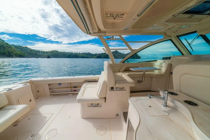 Dos Amigos Yacht Photos Pics 2020 Grady-White Freedom 375 boat interior with ocean view, featuring luxurious seating and amenities.
