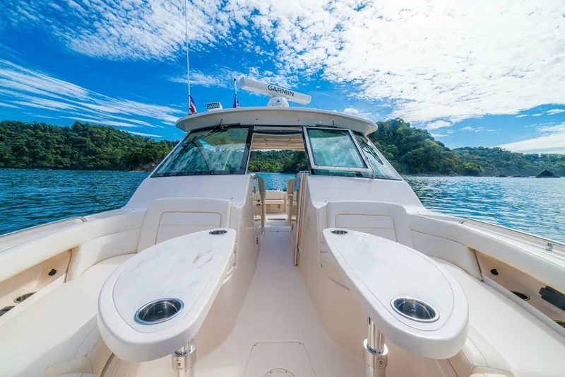 Dos Amigos Yacht Photos Pics 2020 Grady-White Freedom 375 boat on scenic water with lush green backdrop.