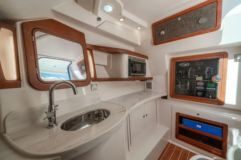 Dos Amigos Yacht Photos Pics Interior of 2020 Grady-White Freedom 375 boat with sink, microwave, and control panel.
