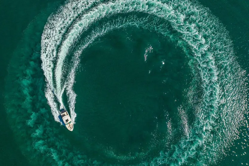 Dos Amigos Yacht Photos Pics Aerial view of 2020 Grady-White Freedom 375 creating circular wake in turquoise water.