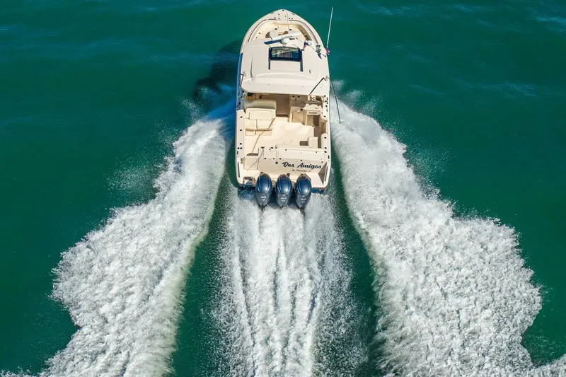 Dos Amigos Yacht Photos Pics 2020 Grady-White Freedom 375 boat cruising on open water, rear view.