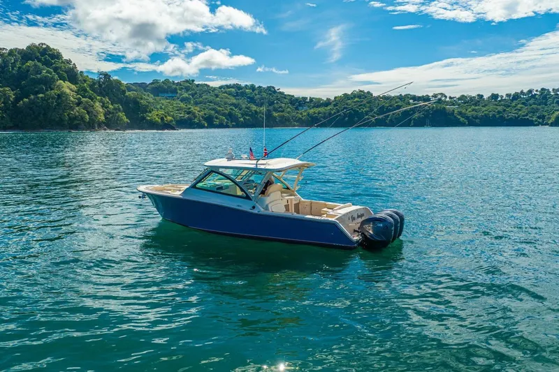 Dos Amigos Yacht Photos Pics 2020 Grady-White Freedom 375 boat on serene water with lush green backdrop.