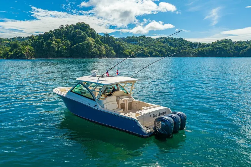 Dos Amigos Yacht Photos Pics 2020 Grady-White Freedom 375 boat on scenic blue water with lush green island backdrop.