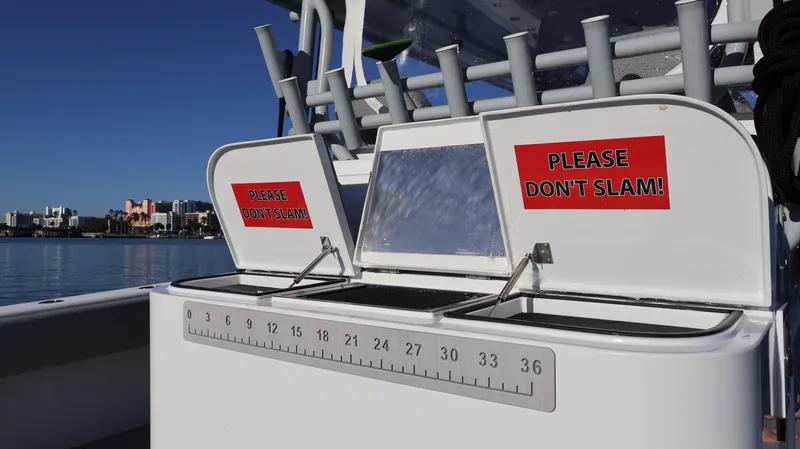  Yacht Photos Pics Freeman 47 boat, 2021 model, with "Please Don't Slam!" signs on storage compartments.