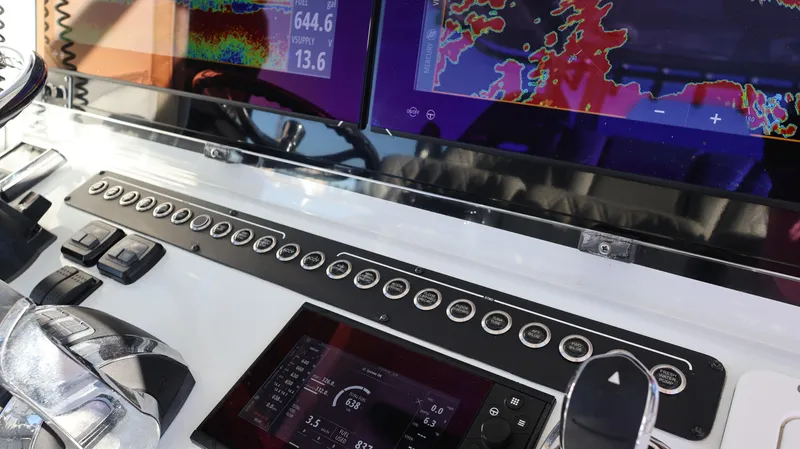  Yacht Photos Pics Control panel of a 2021 Freeman 47 boat with advanced navigation displays and controls.