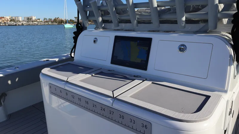  Yacht Photos Pics Freeman 47 boat console with navigation screen, 2021 model, on calm water.