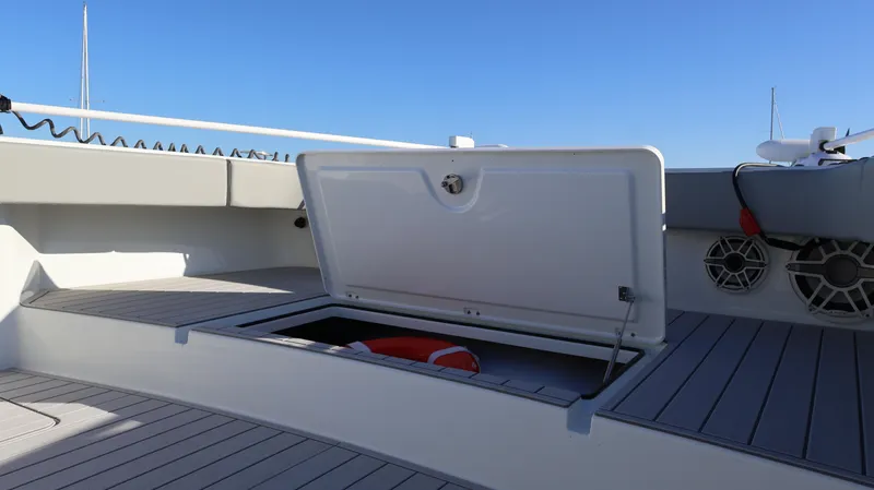  Yacht Photos Pics Open storage compartment on 2021 Freeman 47 boat deck, with life preserver inside.
