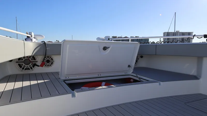  Yacht Photos Pics Open storage compartment on 2021 Freeman 47 boat deck with speakers and city skyline.