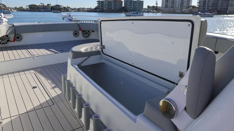  Yacht Photos Pics Open storage compartment on a 2021 Freeman 47 boat, docked by waterfront buildings.