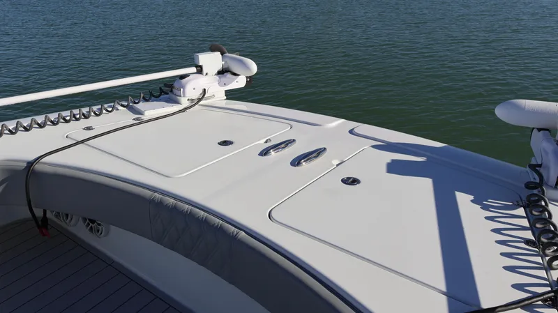  Yacht Photos Pics 2021 Freeman 47 boat deck with fishing equipment, on calm water.