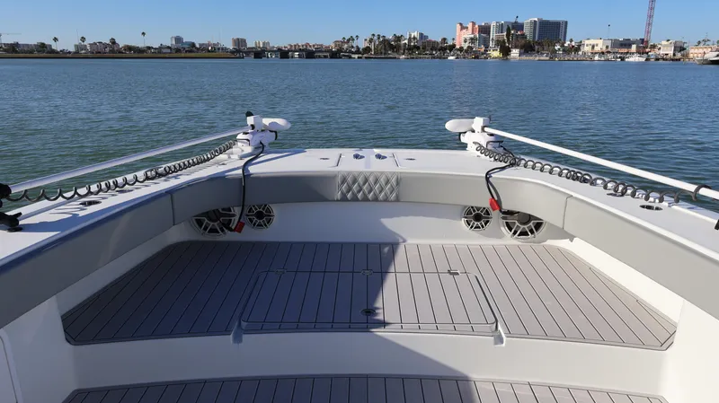  Yacht Photos Pics Bow view of a 2021 Freeman 47 boat on calm waters with cityscape background.