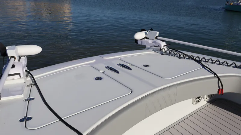  Yacht Photos Pics 2021 Freeman 47 boat deck with storage compartments and fishing equipment, on calm water.