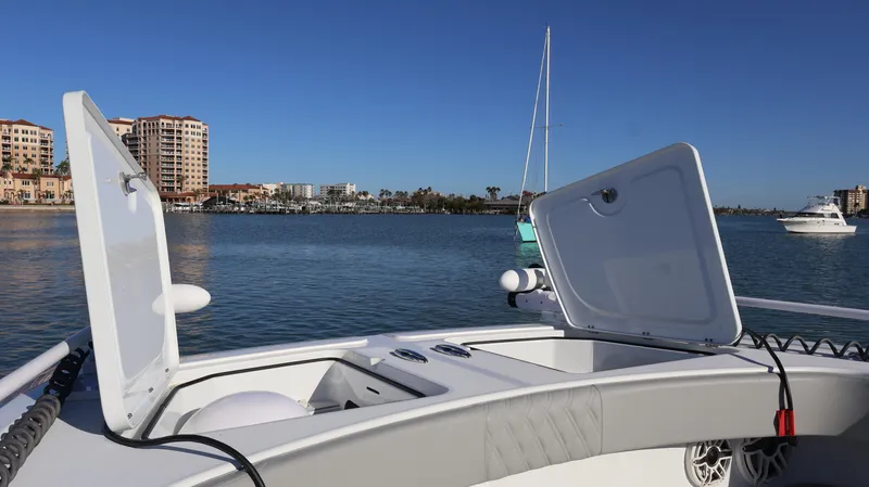  Yacht Photos Pics Freeman 47 boat deck with open hatches, 2021 model, on calm water near cityscape.