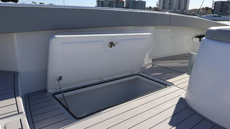  Yacht Photos Pics Open storage compartment on 2021 Freeman 47 boat deck, with cityscape in background.
