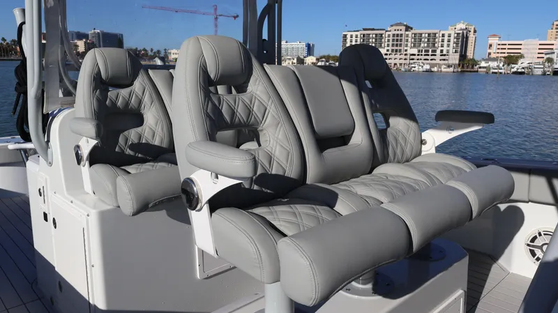  Yacht Photos Pics Luxury seating on a 2021 Freeman 47 boat, featuring quilted gray upholstery.