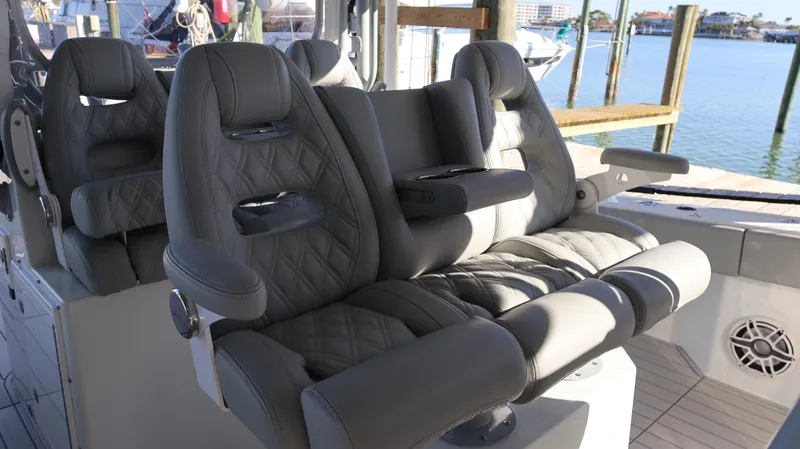  Yacht Photos Pics Luxurious seating on a 2021 Freeman 47 boat, featuring quilted gray leather upholstery.