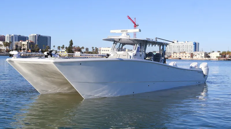  Yacht Photos Pics 2021 Freeman 47 catamaran boat on calm water with cityscape background.