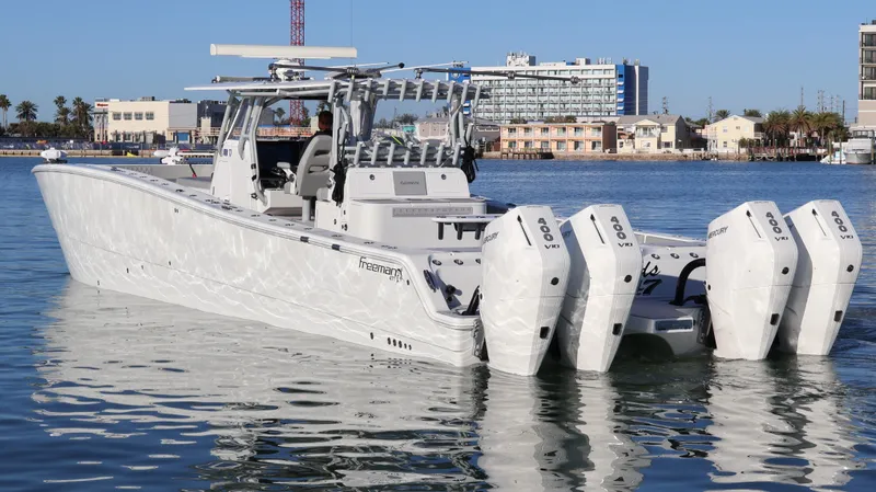  Yacht Photos Pics 2021 Freeman 47 boat with four engines on calm water, cityscape background.