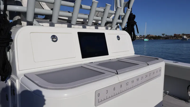  Yacht Photos Pics 2021 Freeman 47 boat console with storage compartments and ruler, docked by the water.