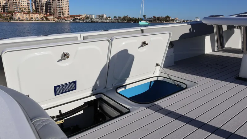  Yacht Photos Pics 2021 Freeman 47 boat deck with open storage compartments, overlooking a waterfront cityscape.