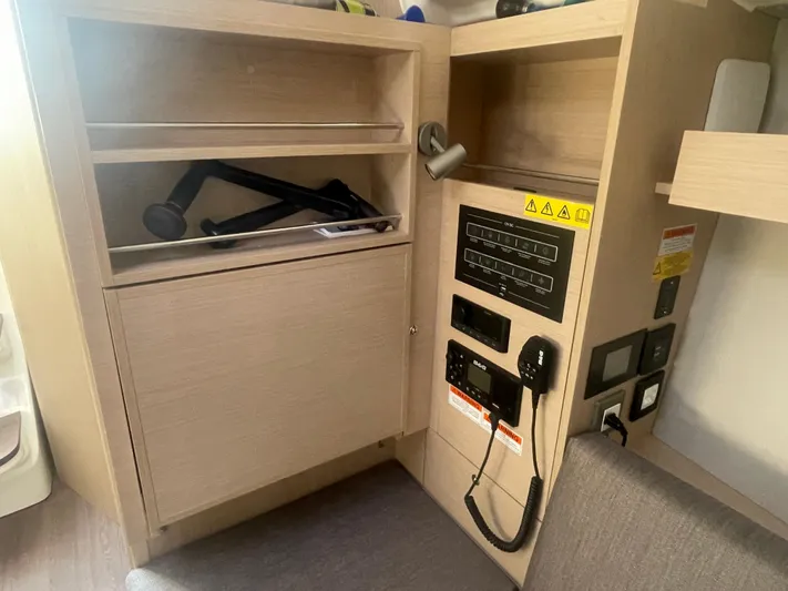 Cutting Edge Yacht Photos Pics Interior of 2023 Beneteau Oceanis 34.1 yacht showing control panel and storage.