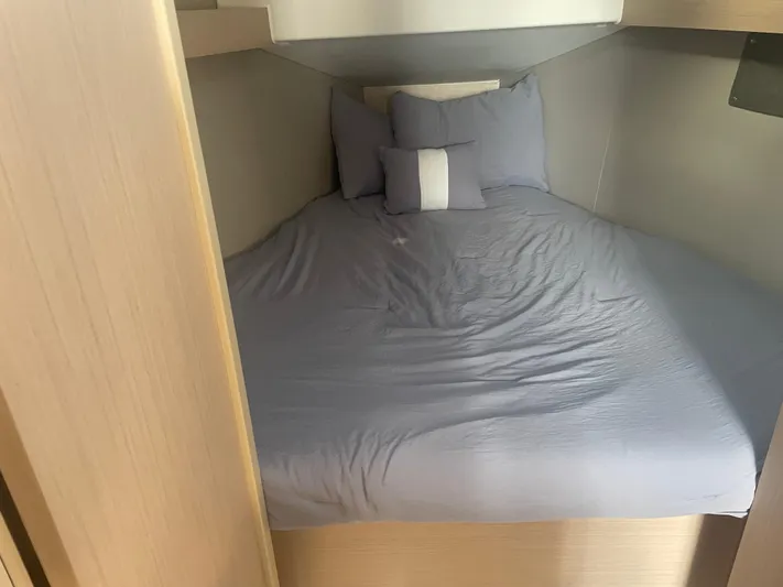 Cutting Edge Yacht Photos Pics Cozy cabin bed in 2023 Beneteau Oceanis 34.1 yacht with blue bedding.