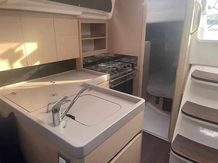 Cutting Edge Yacht Photos Pics 2023 Beneteau Oceanis 34.1 yacht interior with modern kitchen and cozy cabin.