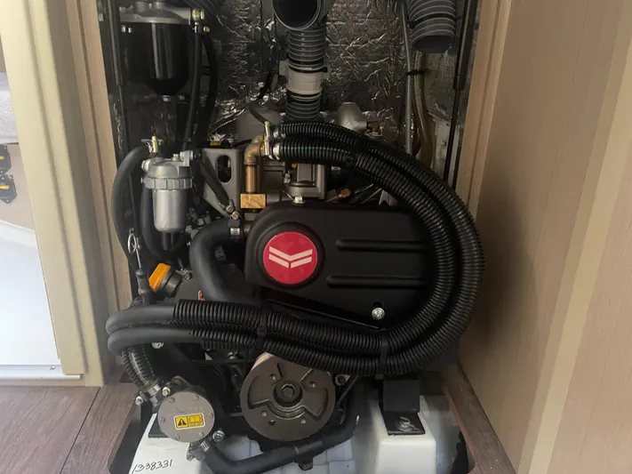 Cutting Edge Yacht Photos Pics Engine compartment of 2023 Beneteau Oceanis 34.1 sailboat, showcasing detailed mechanical components.