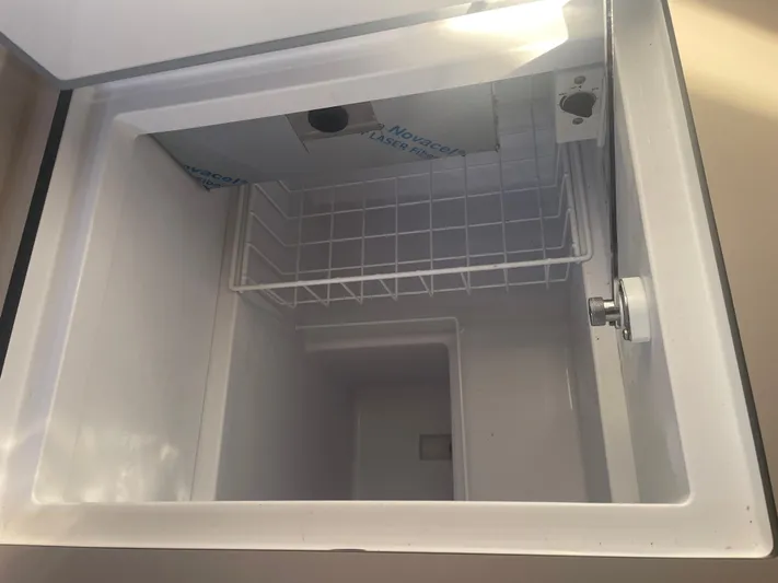 Cutting Edge Yacht Photos Pics Interior view of a 2023 Beneteau Oceanis 34.1 refrigerator compartment.