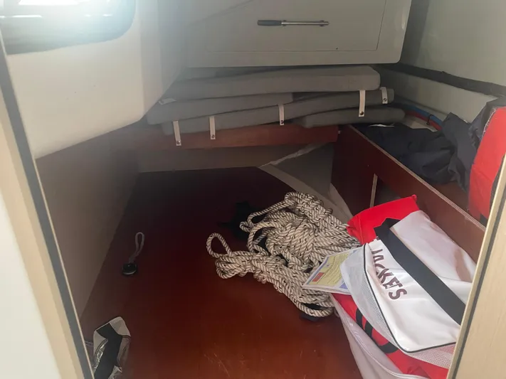 Cutting Edge Yacht Photos Pics Interior cabin of 2023 Beneteau Oceanis 34.1 with ropes and storage.