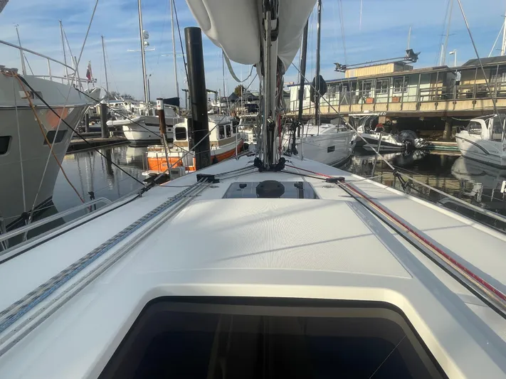 Cutting Edge Yacht Photos Pics 2023 Beneteau Oceanis 34.1 sailboat docked in a marina, showcasing deck and rigging.