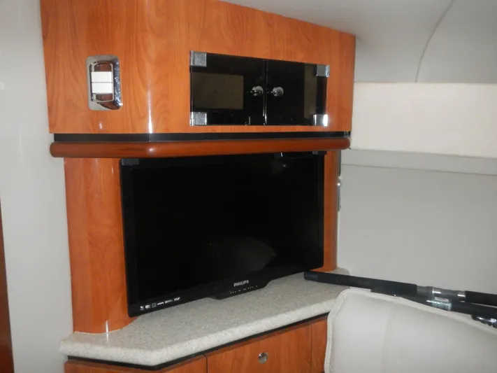  Yacht Photos Pics Interior of 2006 Fountain 48 Express Cruiser with TV and wooden cabinetry.