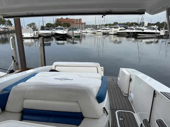  Yacht Photos Pics 2006 Fountain 48 Express Cruiser docked at marina with calm waters and surrounding boats.