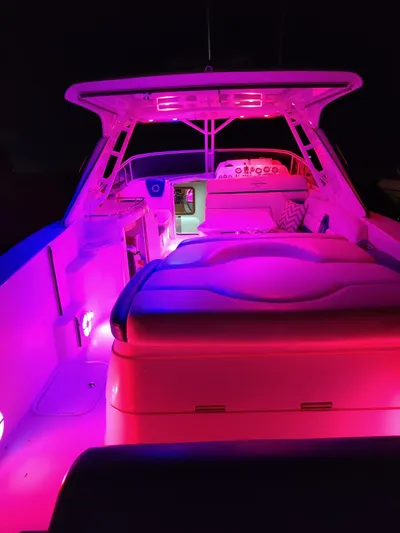  Yacht Photos Pics 2006 Fountain 48 Express Cruiser with vibrant pink interior lighting at night.