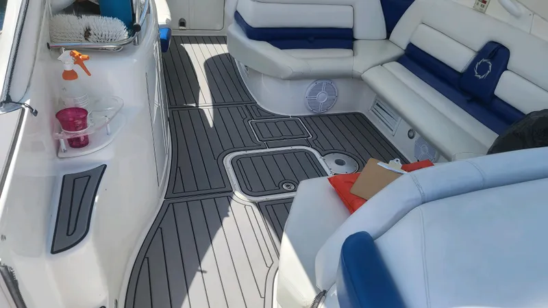  Yacht Photos Pics 2006 Fountain 48 Express Cruiser interior with white and blue seating, gray flooring.