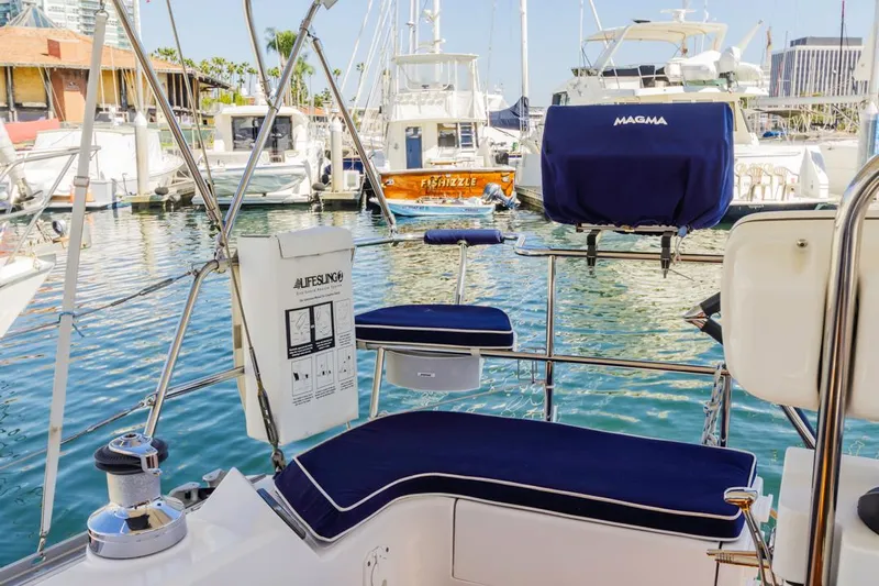 Kia Ora Yacht Photos Pics Catalina 385 sailboat cockpit with blue cushions, docked in a marina, 2014 model.
