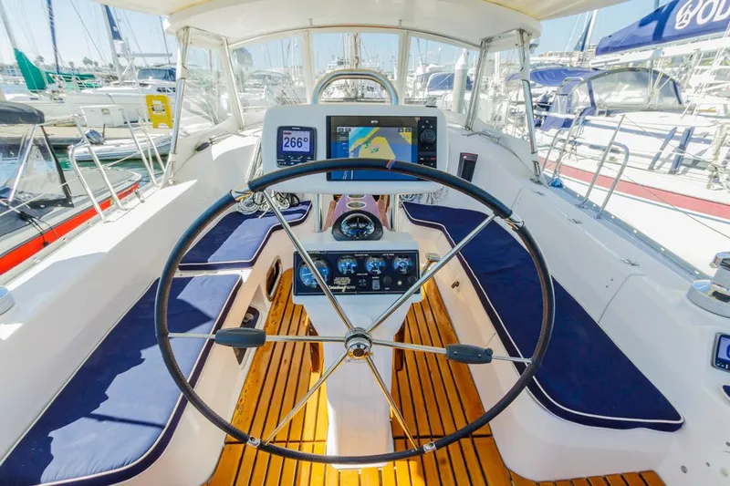 Kia Ora Yacht Photos Pics Catalina 385 sailboat cockpit with navigation equipment and wooden flooring, 2014 model.