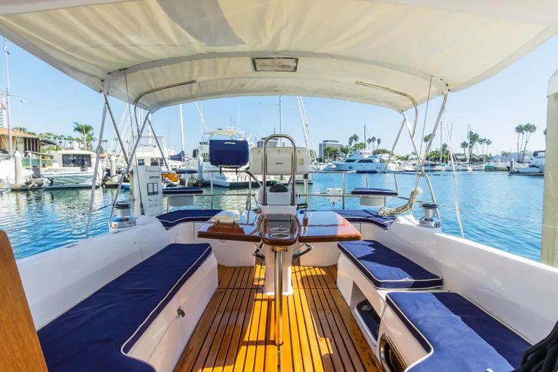Kia Ora Yacht Photos Pics 2014 Catalina 385 sailboat interior with blue seating, docked in a marina.