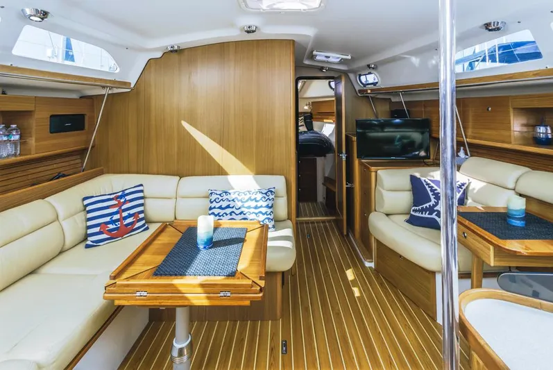 Kia Ora Yacht Photos Pics Luxurious interior of 2014 Catalina 385 sailboat with cozy seating and nautical decor.